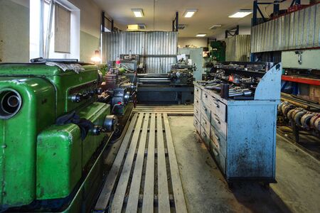 Small metalworking shop. Old lathes. The machine is painted green.