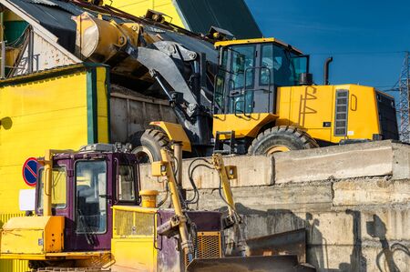 A wheel loader loads sand into a silo. Special construction equipment for earthmoving and handling operations.の写真素材