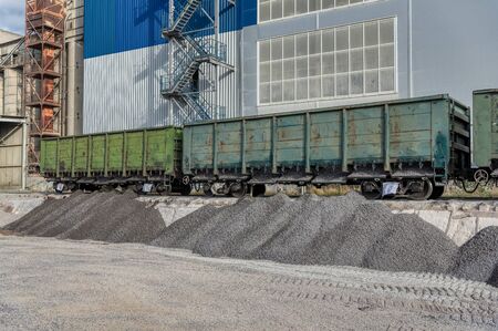 Platform for unloading freight railway cars. Freight train unloaded gravel.の写真素材
