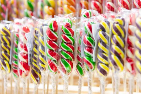 Christmas candy sticks. Multi-colored sucking sweets, holiday sweets. Candies are arranged in an even row.の写真素材