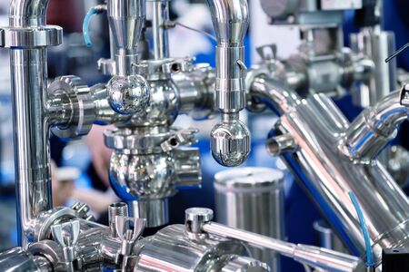 Bright shiny stainless steel piping. System of shutoff valves and metal pipelines. Equipment for the...