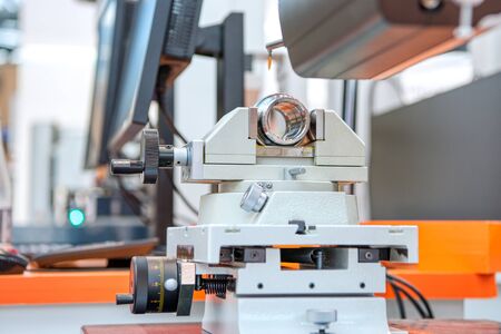 The metal sleeve is clamped in a machine vice.