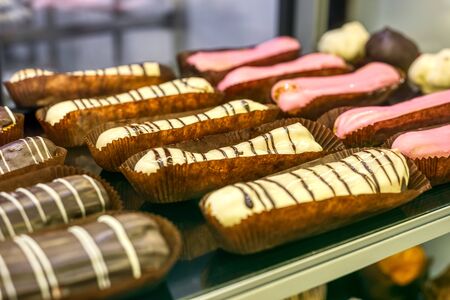 Tasty sweet eclairs in paper baskets.の写真素材