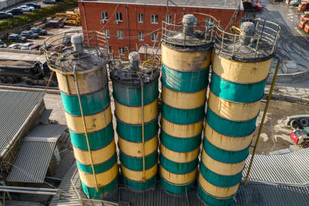 Cement storage silos are painted in yellow-green stripes.の写真素材