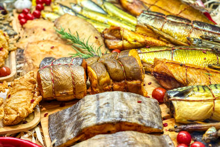 A variety of smoked fish. Beautiful fish showcase. Delicious seafood.の写真素材