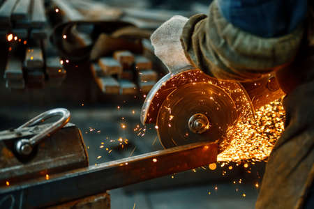 Cutting a metal beam using an angle grinder.の写真素材