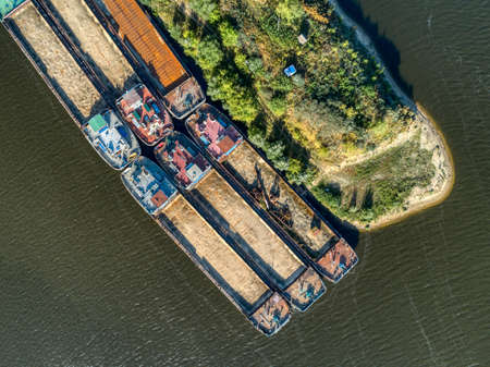 Cargo barges are parked at the pier. River cargo fleet,の写真素材