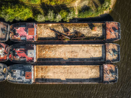 Cargo barges are parked at the pier. River cargo fleet,の写真素材