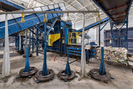 Household waste sorting and recycling plant. Press for pressing plastic bottlesの写真素材