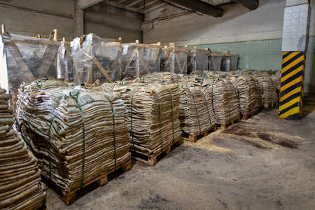 Raw salted cow skins are piled up.