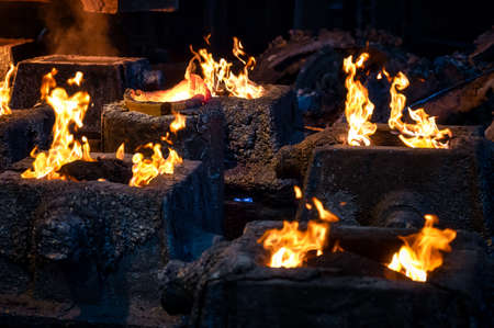 Fire burning over molds after steel casting
