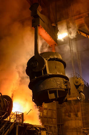 The metallurgical bucket hangs on a special crane beamの写真素材