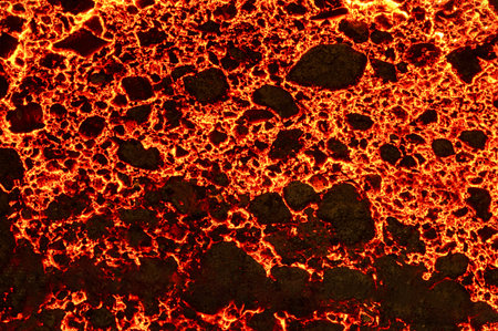 The surface of a hot liquid slag in a metallurgical ladle. Thick crust covered with trash net