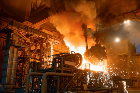 Pouring molten metal into a metallurgical electric arc furnaceの写真素材