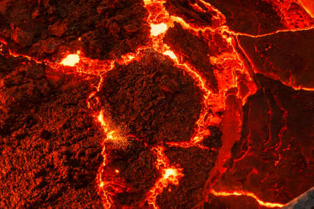 The surface of a hot liquid slag in a metallurgical ladle. Thick crust covered with trash netの写真素材