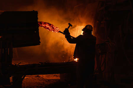 process of taking a sample of liquid metal in a steelmaking furnaceの写真素材