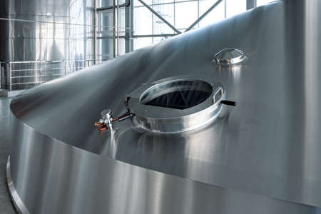 Large steel tanks for yeast fermentation. Industrial production of beer and alcohol
