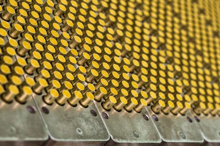 Set of golden bullet shells in metal cartridges on standの写真素材