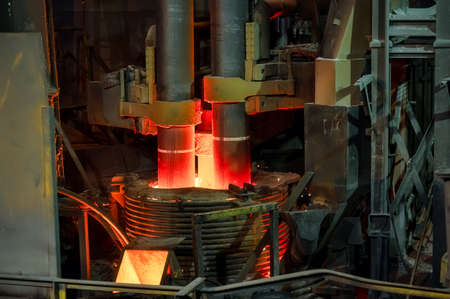 Electric arc steelmaking furnace, thick powerful red-hot graphite electrodesの写真素材