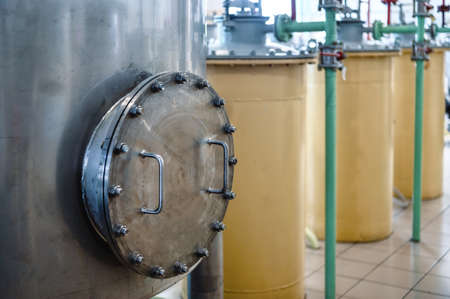 Metal lid with handle on reservoir top at production plant