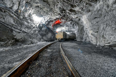 Underground mine. Underground railway for transporting ore. Mine trolley as part of an underground...