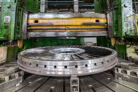 Processed part with vertical turning lathe machine in shop