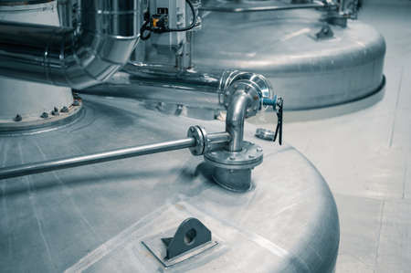 Large tank with processed aggressive liquids in workshopの写真素材