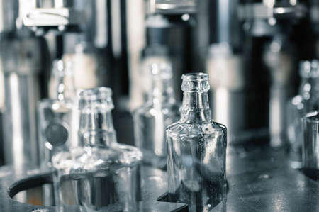 Automatic production line fills glass bottles with vodka