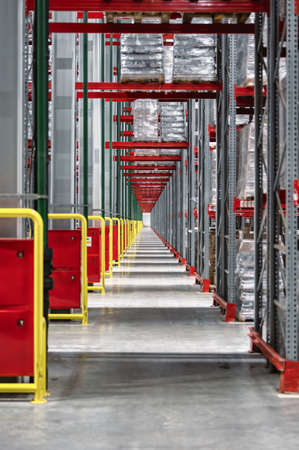 Lifting equipment with cargo near high shelving in storage
