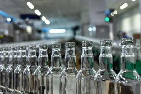 Row of glass bottles to fill with expensive alcohol drinksの写真素材