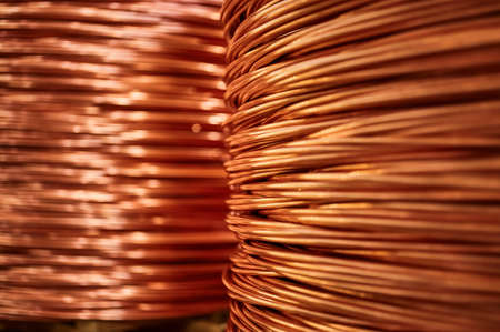 Large bobbin of orange copper wire in light warehouseの写真素材