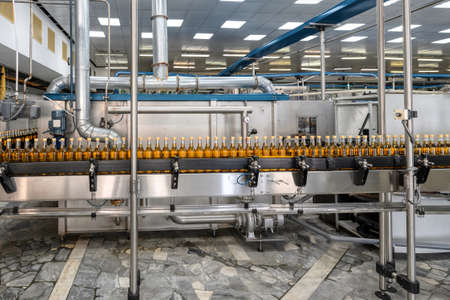 Alcohol liquor closed bottles with caps at production line