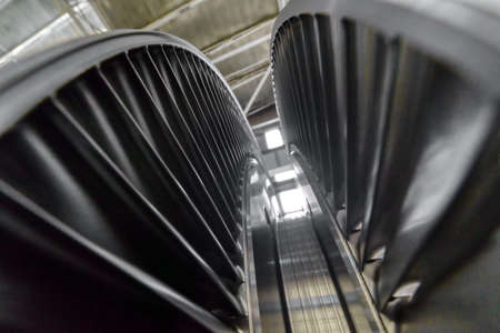 Steam turbine with silver blades in brightly lit workshopの写真素材