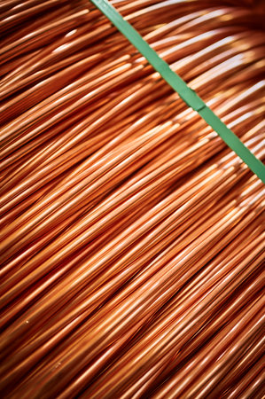 Large bobbin of orange copper wire in light warehouseの写真素材
