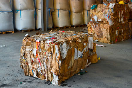 Block of pressed cardboard boxes in litter processing plantの写真素材