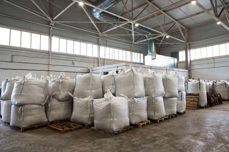 Huge plastic bags with product on pallets at recycling plantの写真素材