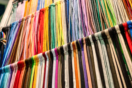 Laces samples hang on rack in light hallway at exhibitionの写真素材