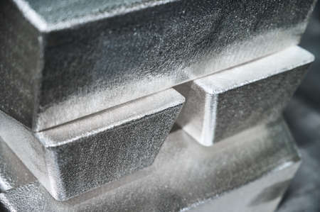 Pile of industrial silver bars at bright light in storageの写真素材