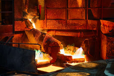 Pouring liquid copper metal for anodes into form in workshopの写真素材