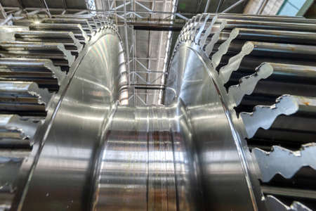 Metal shaft of steam turbine without blades in workshop
