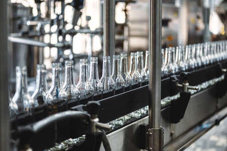 Row of glass bottles to fill with expensive alcohol drinks