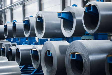 Large rolls of electrical transformer steel hang on rackの写真素材