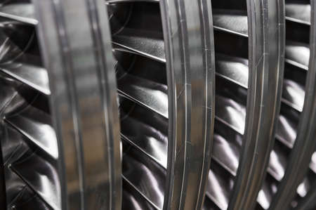 Large steam turbine with shiny blades and holes at plantの写真素材