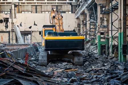 Hydraulic excavators at demolition site of industrial complex