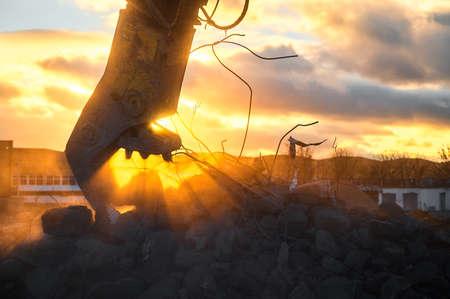 Metal crusher on excavator rigging destroys armored concreteの写真素材