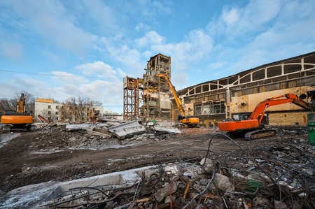 Hydraulic excavators at demolition site of industrial complexの写真素材