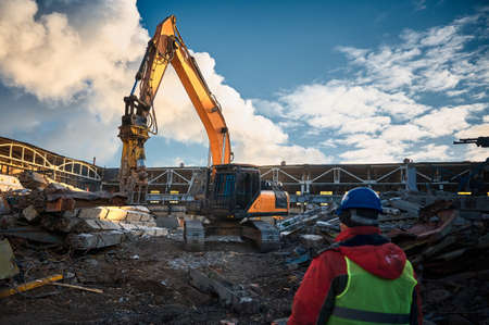 Excavator destroyer removes debris under worker control
