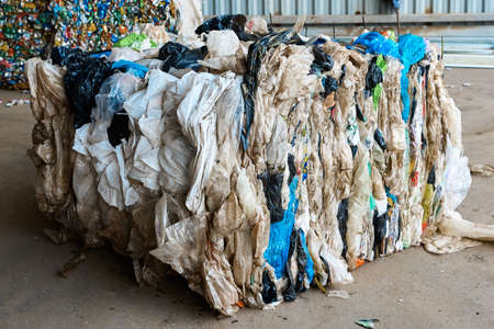 Pressed plastic bags in litter recycling factory storage