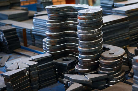 Piles of different workpieces made of metal material sheetの写真素材