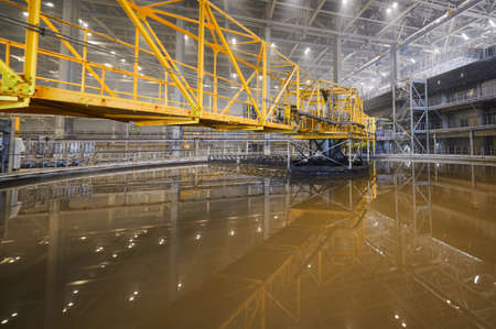 Large round floatation machine tank full of liquid at plant